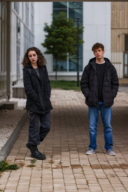 istock Two rebellious souls in dark attire on the street 2192495521