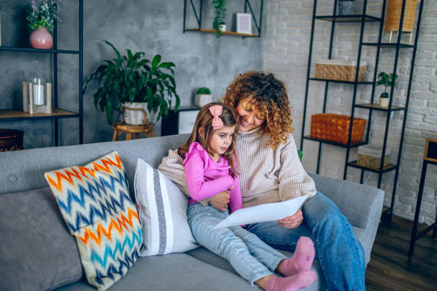 istock Happy daughter shows her drawing to mother 2192496376