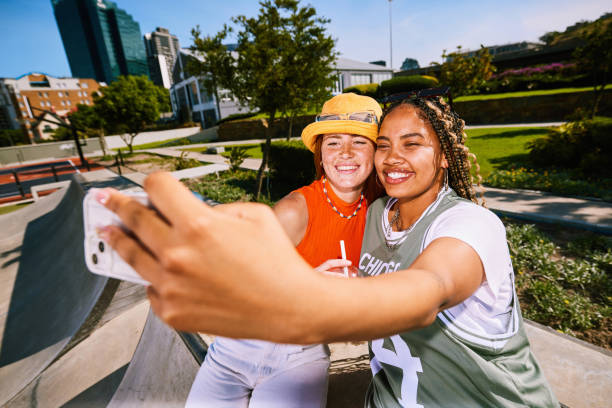 istock Two female friends smiling at phone and taking selfie 2192496948