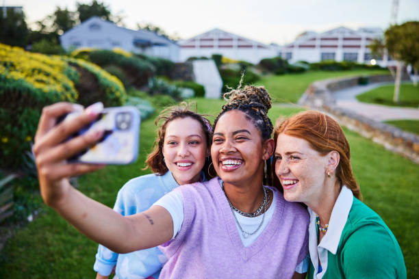 istock Three female friends taking selfie on smartphone, smiling 2192497398