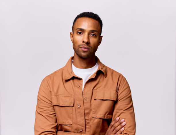 Studio portrait of multiracial mid adult man wearing brown shirt stock photo