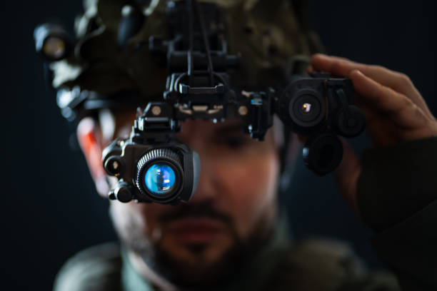 A soldier using modern night vision and thermal imaging in the darkness.