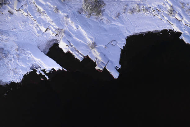 Snowy landscape and the dark lake of Vänern seen from above at Skutberget, Karlstad, Sweden.