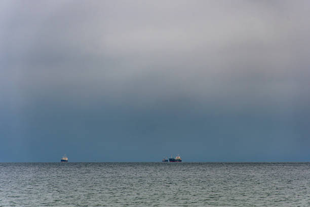 Transportation and Container ships wait on the Baltic Sea in front of the port of Gdynia, Poland.