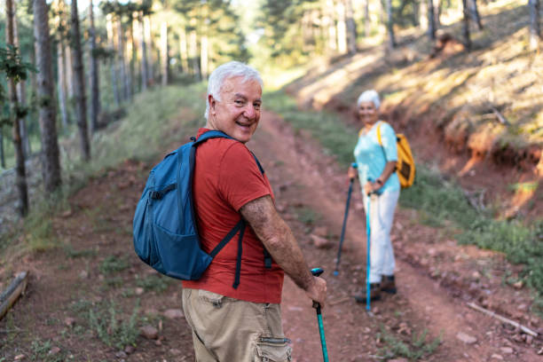 istock Senior couple walking in forest 2192503402