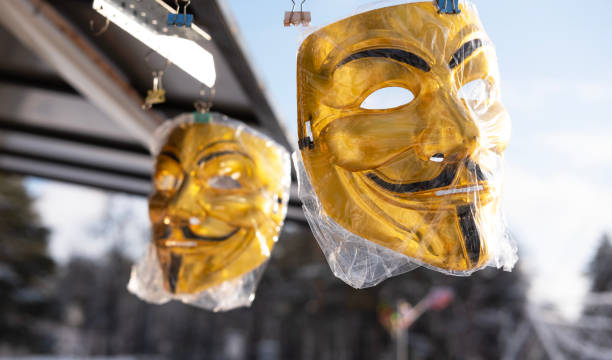 two golden comic masks hanging in a souvenir kiosk