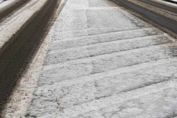 istock Melting snow and ice creating slush on road surface 2192504448