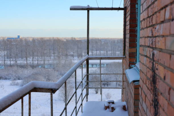 A tranquil winter scene from a decorated balcony, showcasing a serene snowy landscape blanketed in snow
