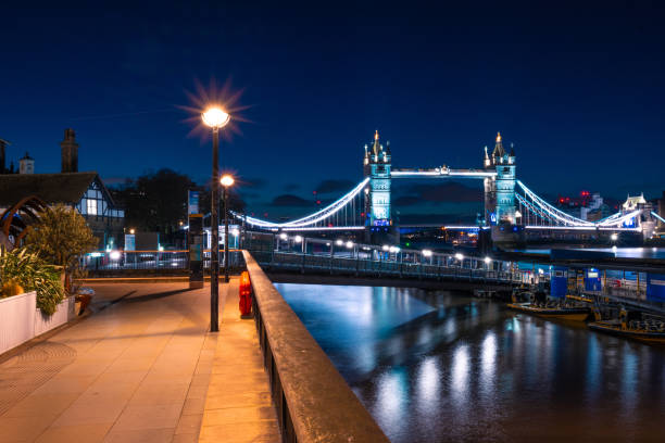 istock Thames riverside walk in London at night 2192506619