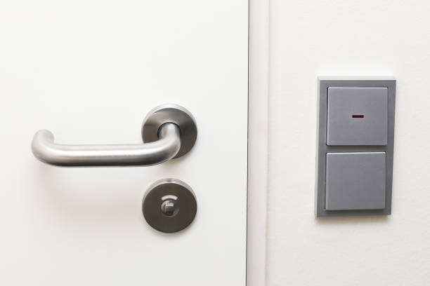istock Hotel room door with a silver handle and light switch nearby. Modern and functional setup. 2192507861