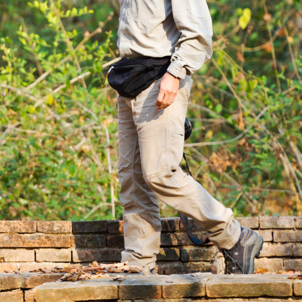istock Man in hiking boots walking on old brick wall 2192511679