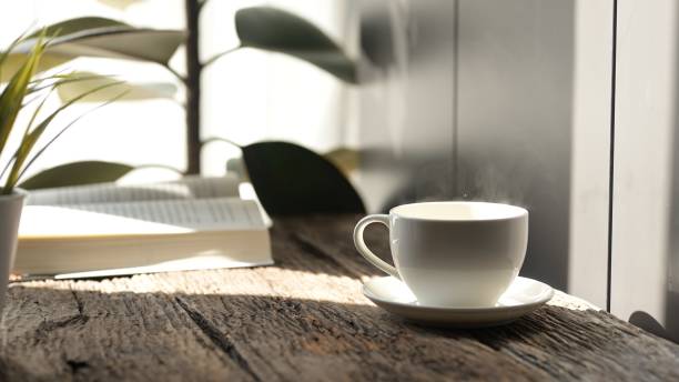 istock Relaxing Coffee Break While Working from Home at Cozy Office Desk with Laptop Warm Atmosphere Focus on Productivity and Comfort 2192513177