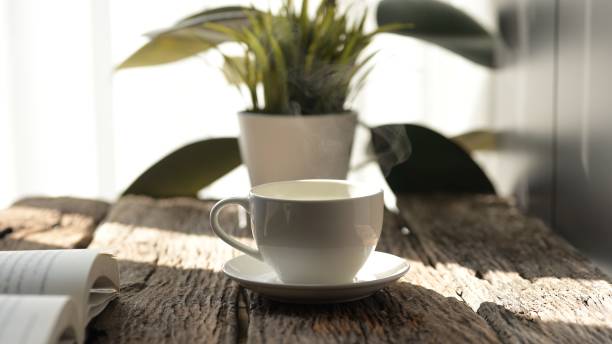istock Relaxing Coffee Break While Working from Home at Cozy Office Desk with Laptop Warm Atmosphere Focus on Productivity and Comfort 2192513179