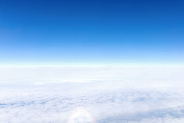 View from airplane window of blue sky with clouds
