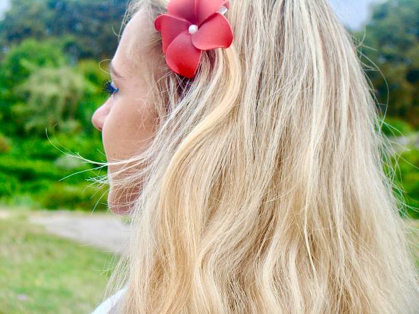Her hair tells the story of summer, and her gaze is set on what lies ahead.