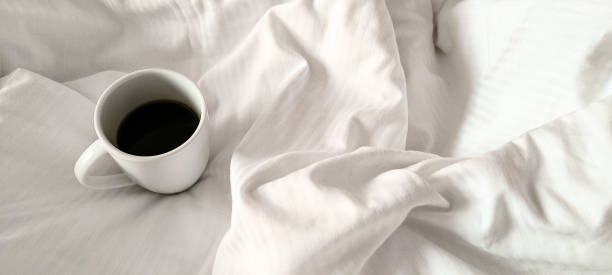istock Fresh morning coffee on white bedding. Relaxation before the working day. Morning routine. 2192515812