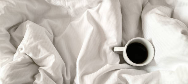 istock Fresh morning coffee on white bedding. Relaxation before the working day. Morning routine. 2192515813