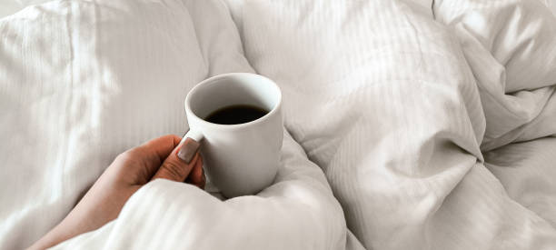 istock Fresh morning coffee on white bedding. Relaxation before the working day. Morning routine. 2192515818