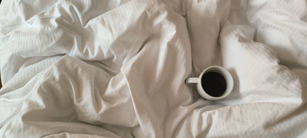 istock Fresh morning coffee on white bedding. Relaxation before the working day. Morning routine. 2192516270