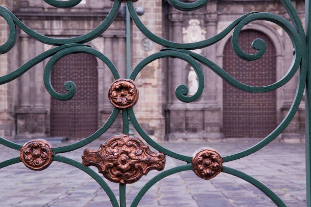 Ornate metal gate featuring copper accents guarding the entrance to puebla cathedral in mexico