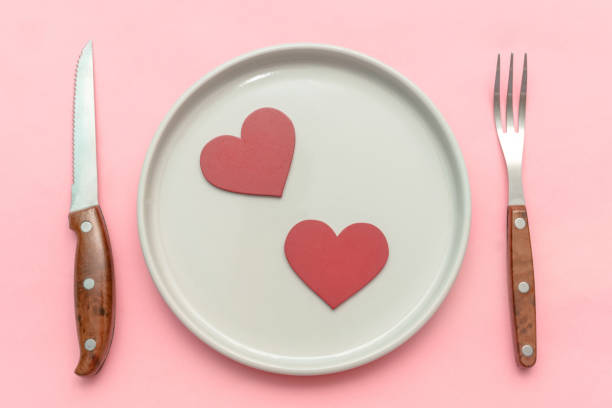 istock Valentine's Day dinner dating concept. tabble serving with cutlery on pink background. Top view flatlay 2192518044