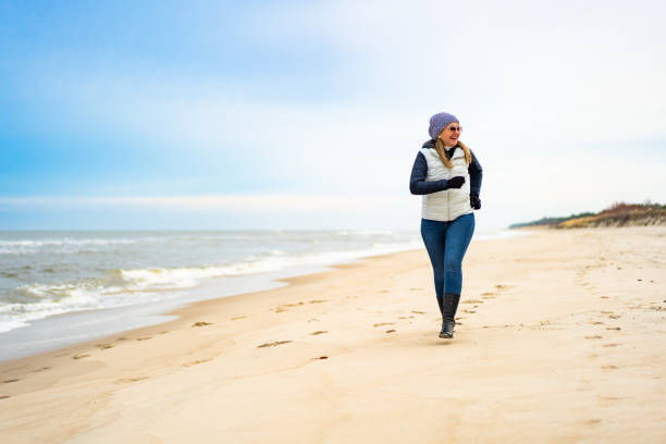 Middle-aged woman exercising on beach