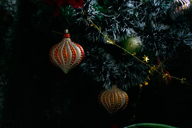 A festive Christmas scene featuring a decorated tree with ornaments, a shining star, plush toys, Santa Claus figurines, and a cozy fireplace. This image captures the warmth and joy of holiday traditions, perfect for projects related to Christmas celebrations, home decor, and seasonal marketing campaigns. Ideal for use in greeting cards, advertisements, and social media content