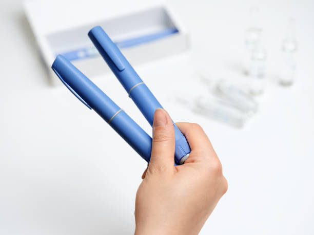 istock Female hands holding Semaglutide injection pen. 2192521485