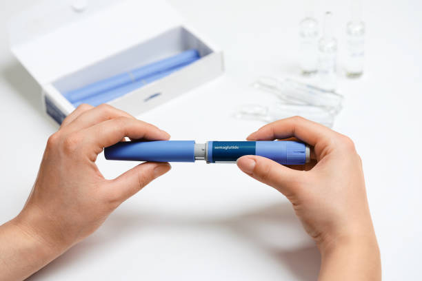 istock Female hands holding Semaglutide injection pen. 2192521486