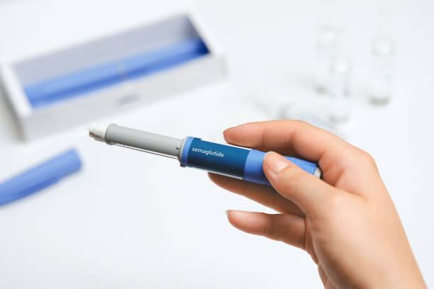istock Female hands holding Semaglutide injection pen. 2192521519