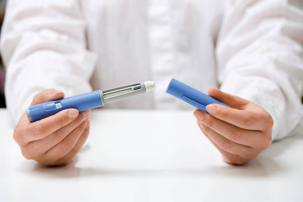 Female hands holding Semaglutide injection pen.