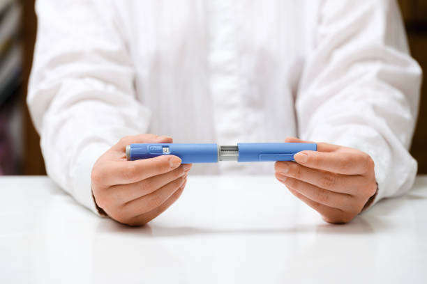 istock Female hands holding Semaglutide injection pen. 2192521550