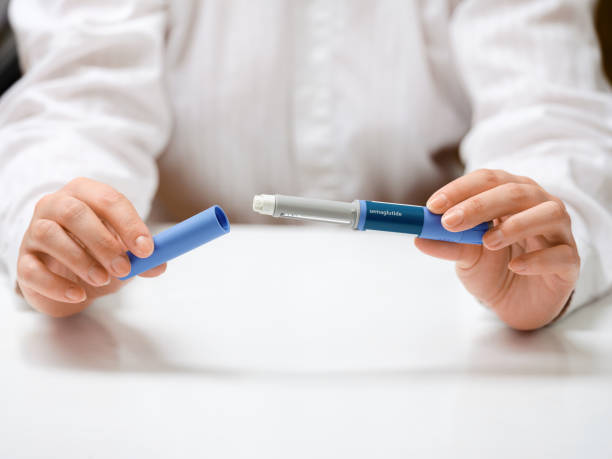 istock Female hands holding Semaglutide injection pen. 2192521571