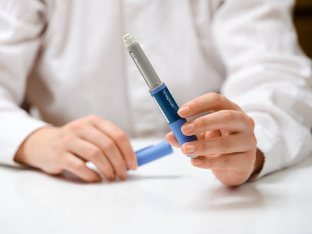 istock Female hands holding Semaglutide injection pen. 2192521581