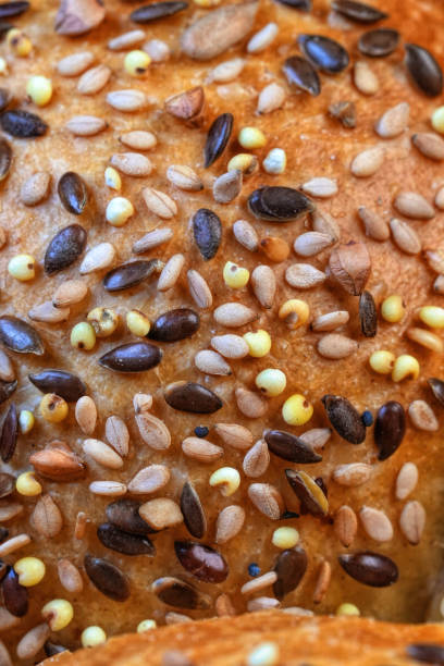 Close-up of a seeded bread crust with various seeds like sesame and poppy.
