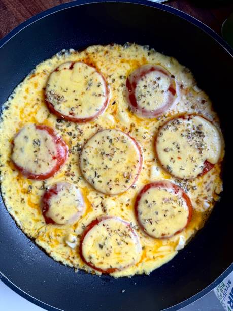 Fried tomatoes and cheddar cheese in pan