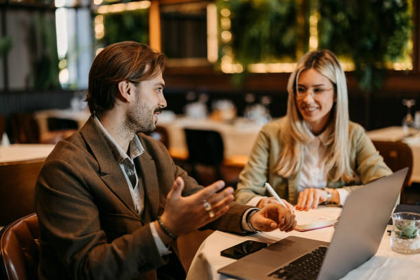 istock Coworkers talking and working in restaurant 2192525031