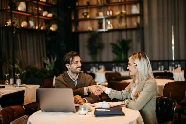 istock Business people shaking hands at lunch meeting s 2192525041