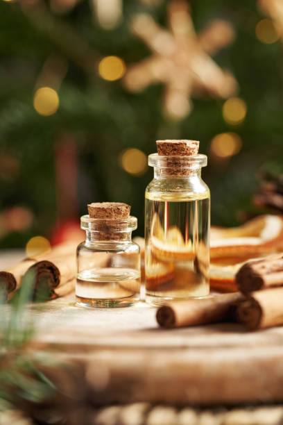 istock Two transparent bottles of aromatherapy essential oil with Ceylon cinnamon sticks and Christmas decoration 2192526513