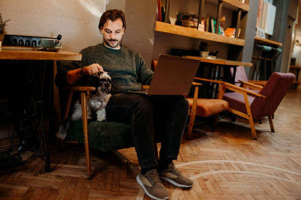 istock Man with dog in cafe 2192526567