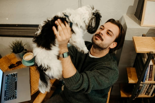 istock Man with dog in cafe 2192526568