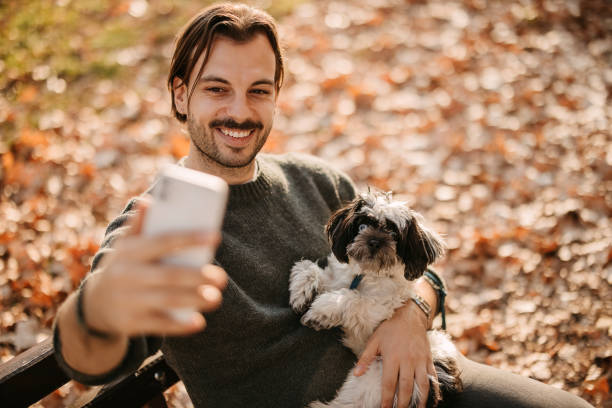 istock Man with a dog in the park. 2192526606