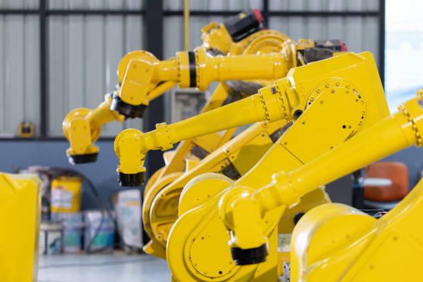 istock Industrial robotic arms arranged in a modern manufacturing facility 2192526686