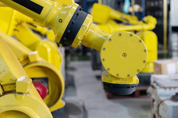 istock Industrial robotic arms arranged in a modern manufacturing facility 2192526687