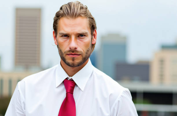 istock Businessman looking at camera with serious expression in an urban setting 2192528400