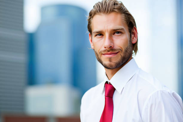 istock Businessman smiling in front of office buildings 2192528409