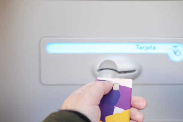 Customer is inserting their credit card into an atm, ready to perform a banking transaction, highlighting the convenience of modern financial technology