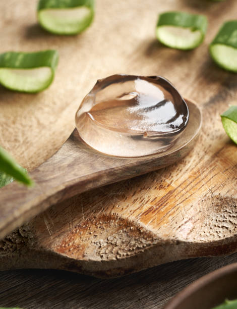 istock Aloe vera gel on a wooden spoon with fresh sliced leaves 2192529310
