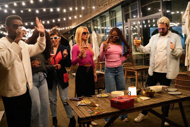 istock Multiethnic friends enjoying drinks and dancing at rooftop party 2192531866