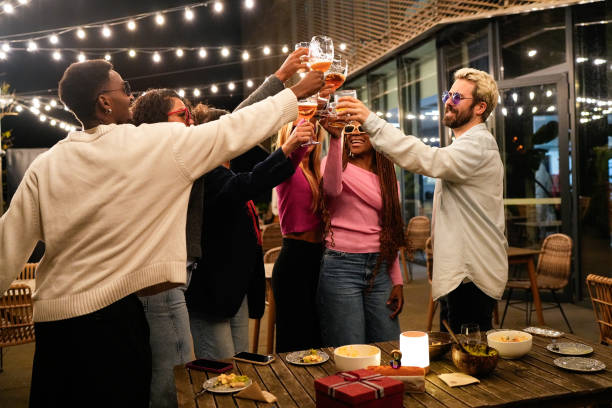 istock Multiethnic friends toasting drinks at outdoor party 2192531867